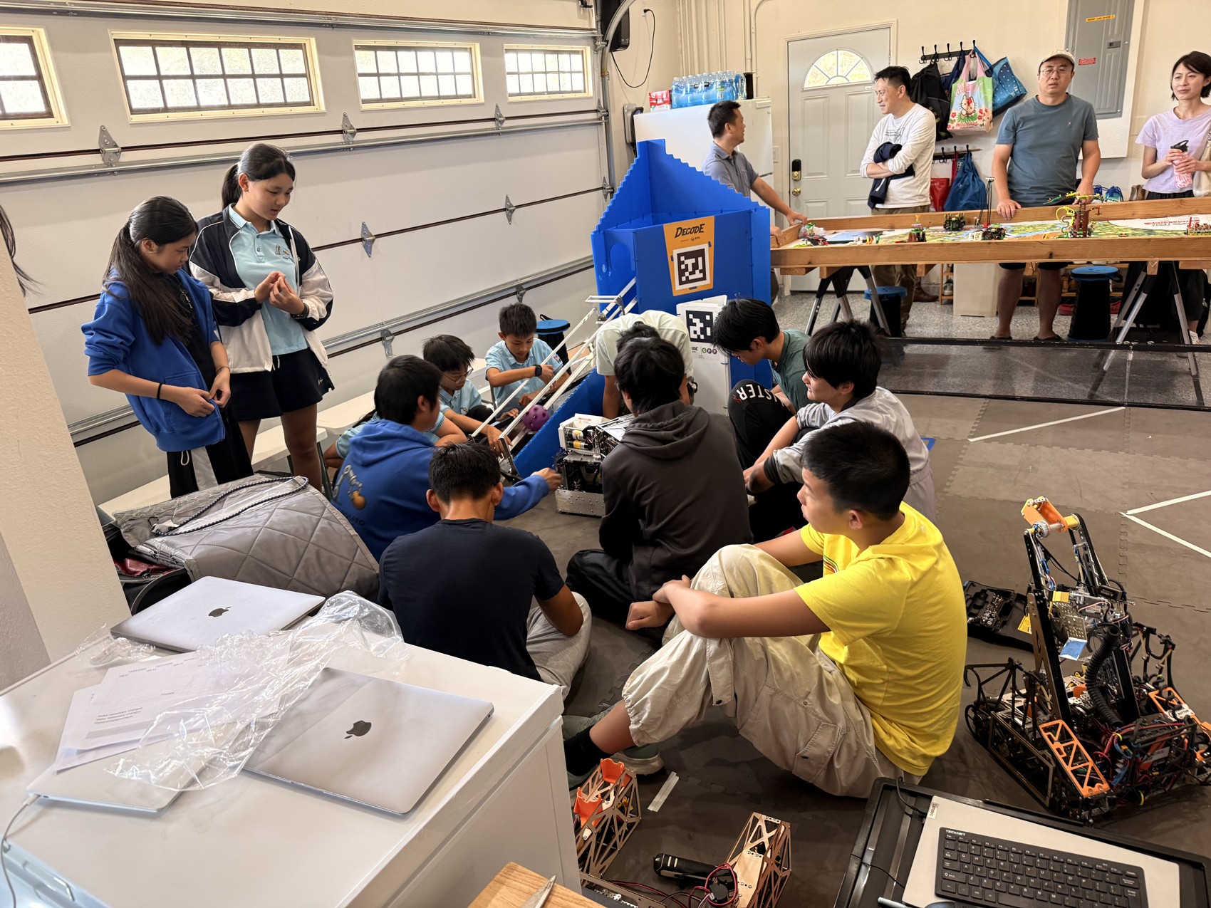 Students and adults gathered around a robot during Little Potato outreach