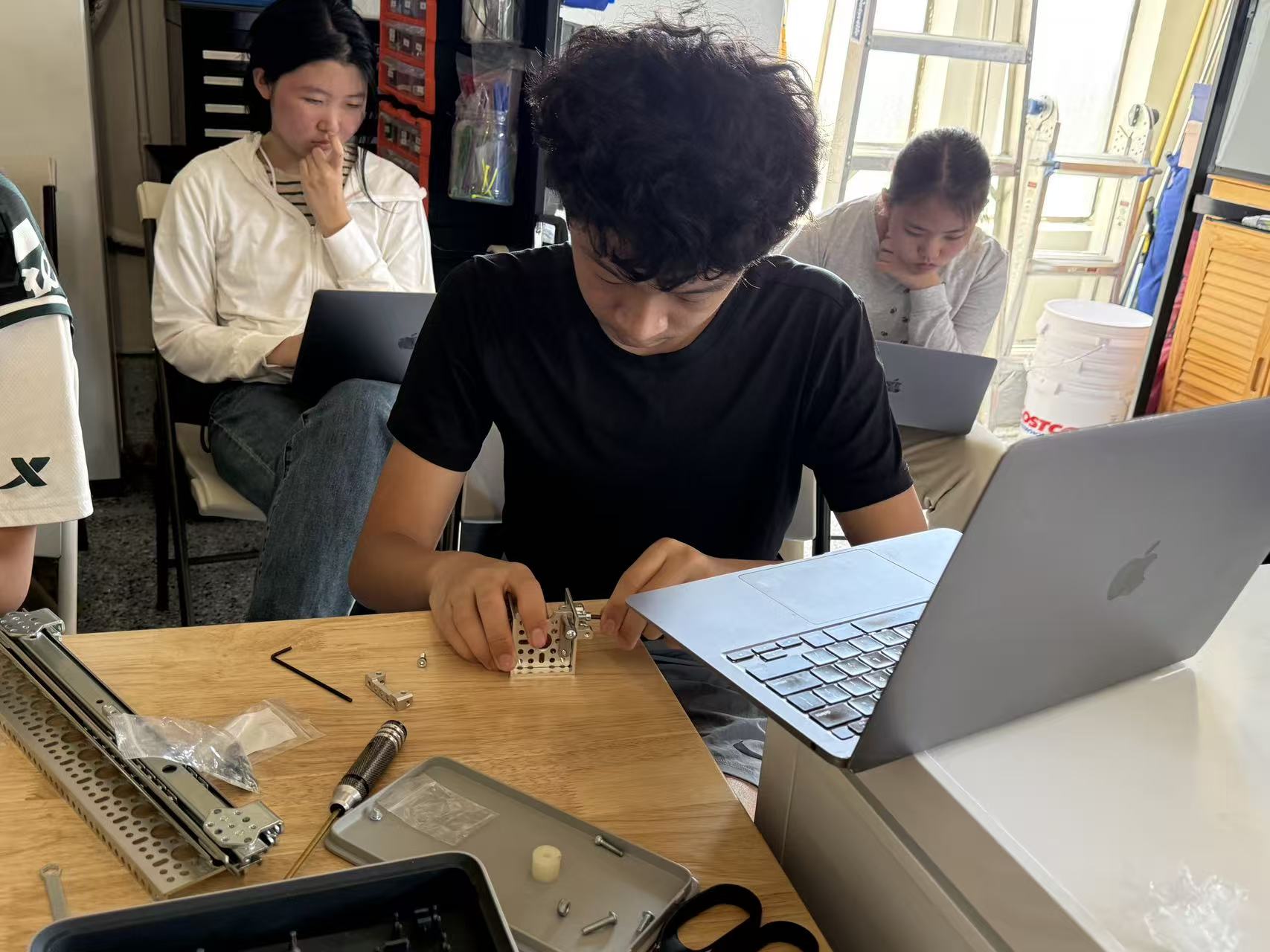 A Paragon student practicing mechanical assembly at a work table
